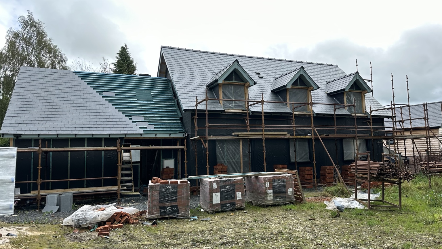 Oak frame dwelling during roof and brickwork progress