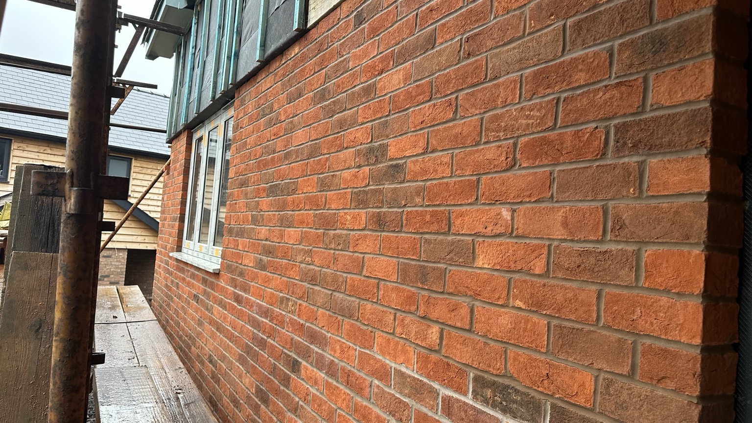 Close view of the brickwork package on an oak frame dwelling in Llanwnog